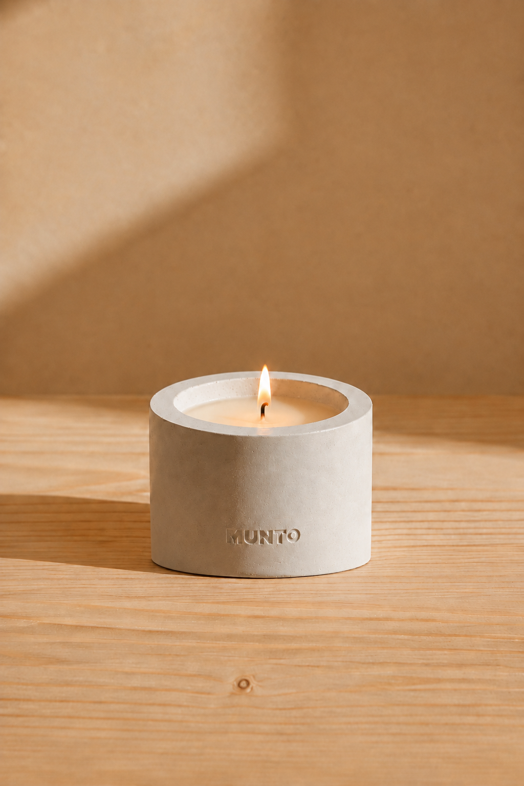Small Munto candle in a white concrete vessel